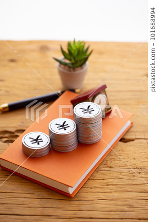 Money piled up on a book (yen) Money piled up on a book (yen) 101688994