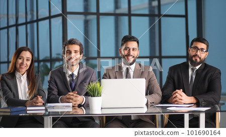 Human resources team sitting in a row at table Stock Photo