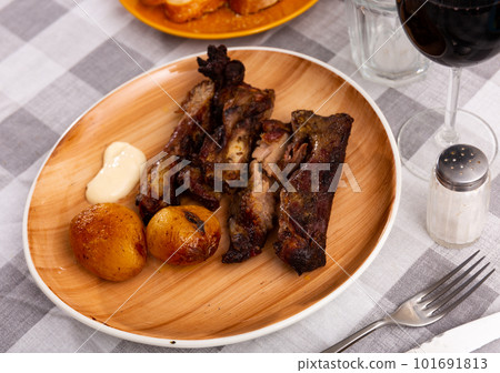 Delicious fried pork ribs with baked potatoes 101691813