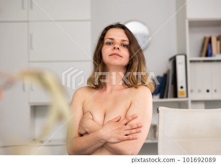 Portrait of naked woman standing in office Portrait of naked woman standing in office 101692089