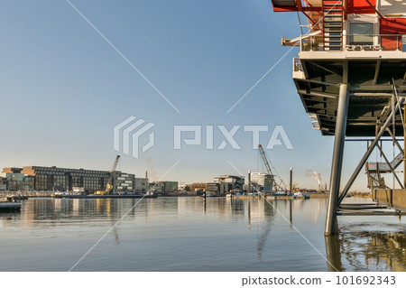 a boat in the water with buildings in the background and blue sky overcasted by some boats on the water a boat in the water with buildings in the background and blue sky overcasted by some boats on the water 101692343