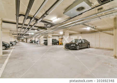 an underground parking area with cars parked in the space and no one on the ground to see how it's going an underground parking area with cars parked in the space and no one on the ground to see how it's going 101692348