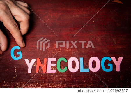 GYNECOLOGY. Text from colorful alphabet letters on a painted wooden background 101692537