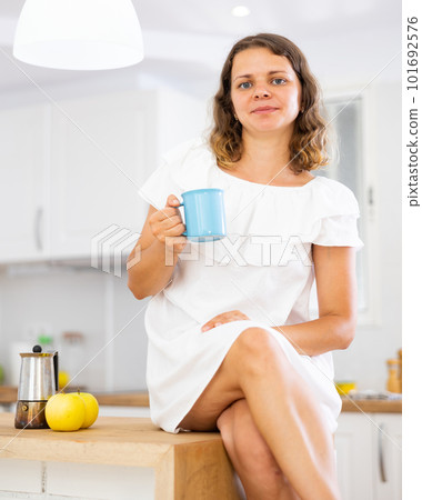 Portrait of attractive woman drinking coffee at home 101692576