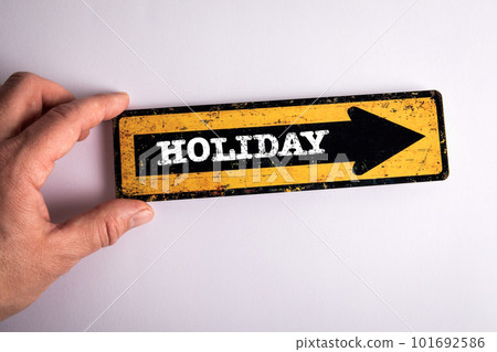Holiday Concept. Pointing arrow with text and a man's hand on a white background Holiday Concept. Pointing arrow with text and a man's hand on a white background 101692586