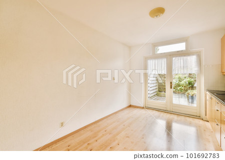 an empty kitchen with wood flooring and white walls in a room that has been cleaned for the next year 101692783