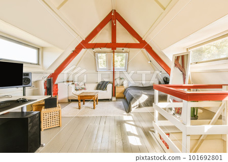 a living room with wood flooring and an attic - style loft that has been used as a home office 101692801