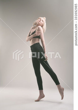 Slim young woman in sportive outfit dancing in studio 101692985
