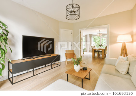 a living room with white couches and a flat screen tv mounted on the wall in the center of the room a living room with white couches and a flat screen tv mounted on the wall in the center of the room 101693150