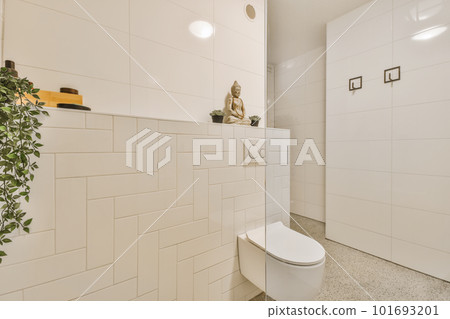 a bathroom with white tiles on the walls, and a potted plant in the corner next to the toilet a bathroom with white tiles on the walls, and a potted plant in the corner next to the toilet 101693201