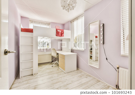 a small room with pink walls and white trim around the window sies, an office desk is on the right side a small room with pink walls and white trim around the window sies, an office desk is on the right side 101693243
