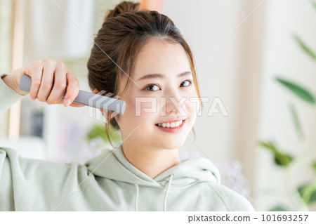 young woman doing hair set 101693257