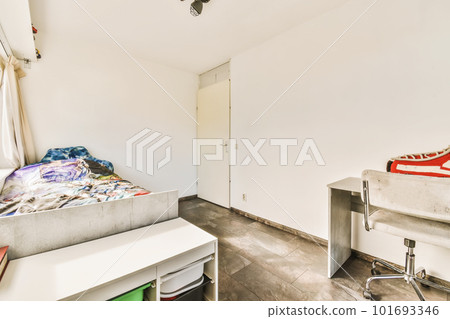 a room with a bed, desk and other items on the floor in front of the door that leads to another room 101693346