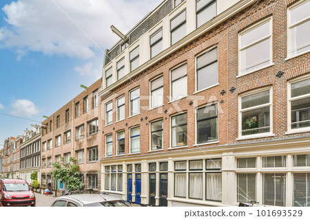 a city street with cars parked on the side and buildings in the middle part of the photo is clear blue sky a city street with cars parked on the side and buildings in the middle part of the photo is clear blue sky 101693529