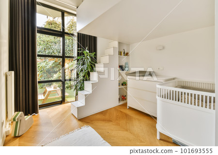 a white room with wood flooring and black drapes on the window simh is in front of the door a white room with wood flooring and black drapes on the window simh is in front of the door 101693555