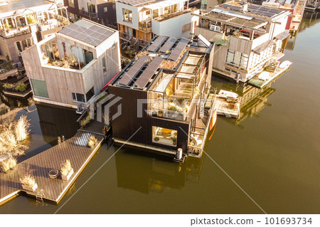 some houses that are floating on the water in the middle of an urban area with lots of them to be some houses that are floating on the water in the middle of an urban area with lots of them to be 101693734