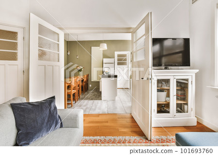 a living room with a couch, tv and fireplace in the center of the room there is a rug on the floor 101693760