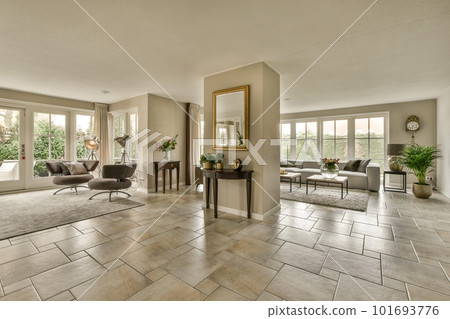 a living room with couches, chairs, and a large mirror on the wall in the center of the room a living room with couches, chairs, and a large mirror on the wall in the center of the room 101693776