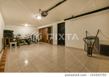 a room that is very clean and ready to be used as a home gym or fitness center with equipment on the floor 101693793