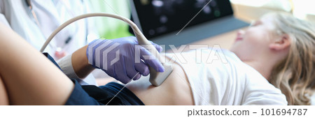 Practitioner examines with ultrasound of internal organs of little girl in clinic Practitioner examines with ultrasound of internal organs of little girl in clinic 101694787