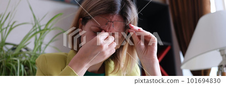 Overworked woman sitting at workplace in office Overworked woman sitting at workplace in office 101694830