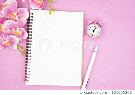 The blank open notebook and clock with pink color orchid for your text or message. 101695806