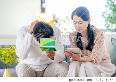 Senior couple looking at pension book Senior couple looking at pension book 101701962