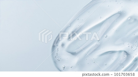 Serum gel smear on blue background. Cosmetic transparent gel serum texture. Serum gel smear on blue background. Cosmetic transparent gel serum texture. 101703658