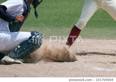 A catcher who stretches his body to stop a ball thrown by a pitcher who sees off the batter during a baseball game A catcher who stretches his body to stop a ball thrown by a pitcher who sees off the batter during a baseball game 101704004