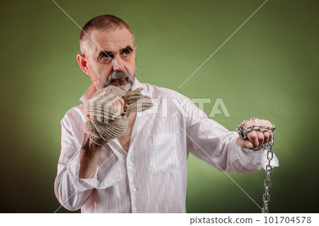 Aggressive elderly man with a chain in his hand 101704578