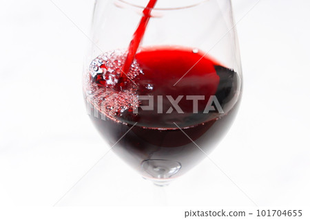 Pouring red wine into a wine glass 101704655