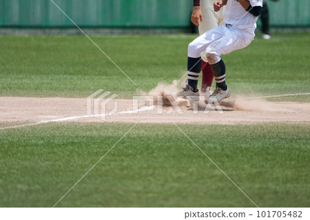 A runner who runs to third base and looks for the next base during a baseball game A runner who runs to third base and looks for the next base during a baseball game 101705482