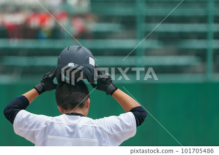 A back view of a player sent as a substitute during a baseball game refitting his helmet A back view of a player sent as a substitute during a baseball game refitting his helmet 101705486
