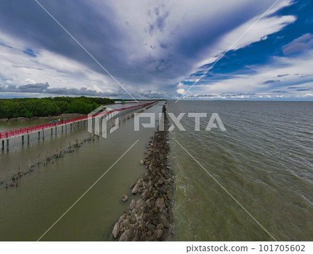 Red Boardwalk Bridge as a viewpoint near Matchanu Shrine,Samut Sakhon,Thailand. River and clouds Red Boardwalk Bridge as a viewpoint near Matchanu Shrine,Samut Sakhon,Thailand. River and clouds 101705602