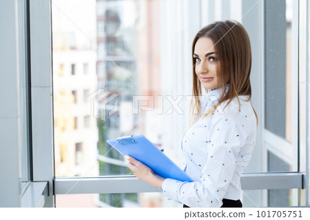 Portrait of young beautiful business woman in the office 101705751