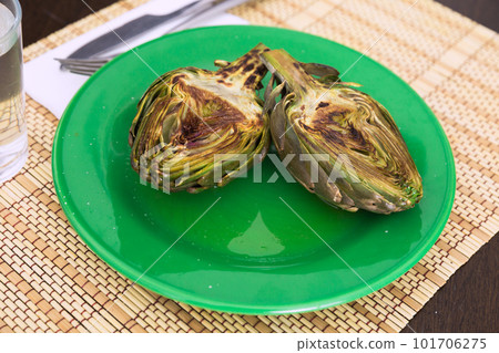 cooked fried halves artichokes on green plate cooked fried halves artichokes on green plate 101706275