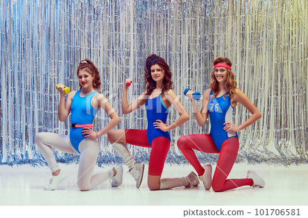 Sportive, athletic, young women in blue and red sportswear, leggings and bodysuits training with dumbbells, doing exercises Sportive, athletic, young women in blue and red sportswear, leggings and bodysuits training with dumbbells, doing exercises 101706581