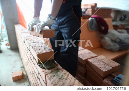 Closeup of industrial bricklayer laying bricks at construction site 101706756