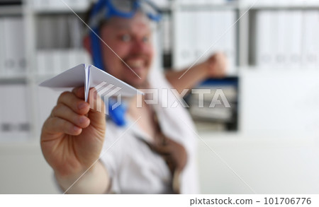 Man in swimming goggles plays and launches paper airplane in office Man in swimming goggles plays and launches paper airplane in office 101706776