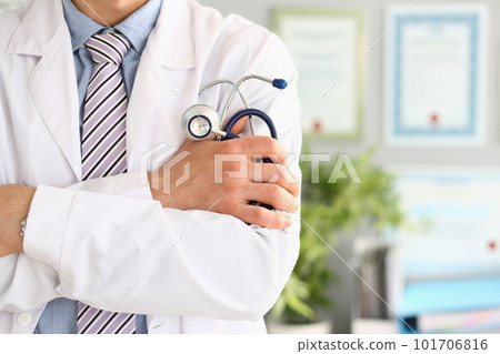 Young and confident male doctor with stethoscope in hands 101706816