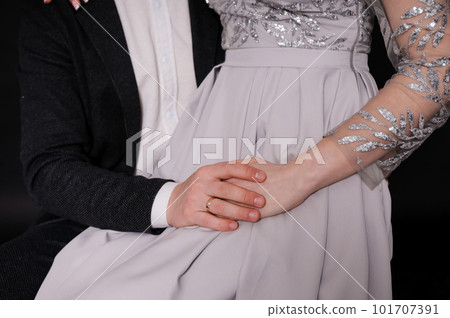 Wedding gold rings on the hands of the newlyweds. Gold rings on the hand of a man and a woman 101707391
