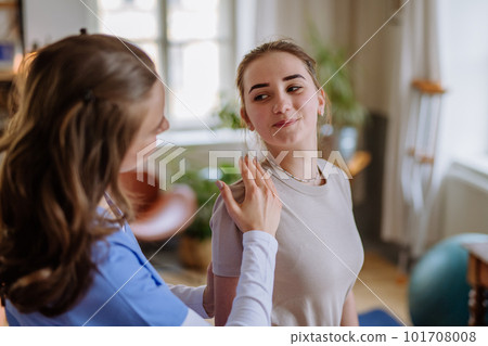 Teenage girl doing exercise with a nurse. Teenage girl doing exercise with a nurse. 101708008
