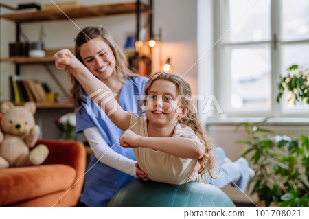 Little girl doing exercise with a nurse. 101708021