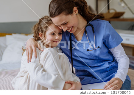 Young doctor hugging little girl in hospital room. Young doctor hugging little girl in hospital room. 101708045