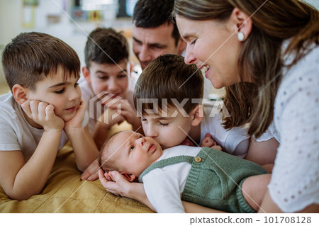 Big family with four kids enjoying their newborn baby. Big family with four kids enjoying their newborn baby. 101708128