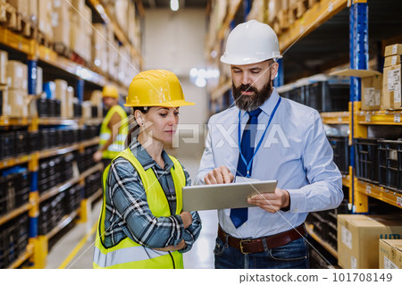 Manager explaining work to his employers in warehouse. Manager explaining work to his employers in warehouse. 101708149