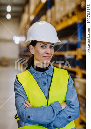 Portrait of warehouse female worker in reflective vest. 101708188