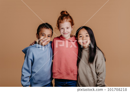 Portrait of three children, studio shoot. Concept of diversity in friendship. 101708218