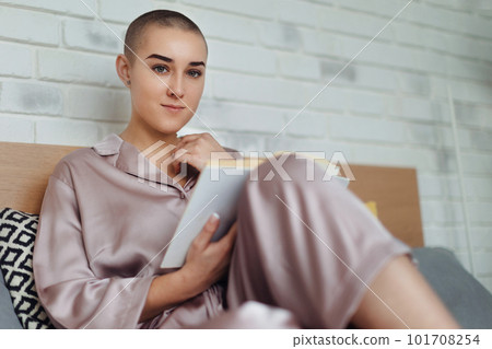 Young woman with cancer reading book, cancer awareness concept. 101708254