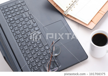 Image of desk work on a laptop while drinking coffee Image of desk work on a laptop while drinking coffee 101708375